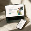 A laptop and a smartphone displaying the Nikki Vasconez Animal Communicator sales page redesign on a neutral surface.